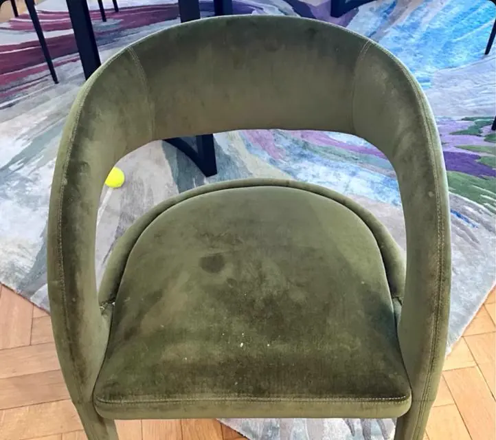 Before cleaning: green velvet chair