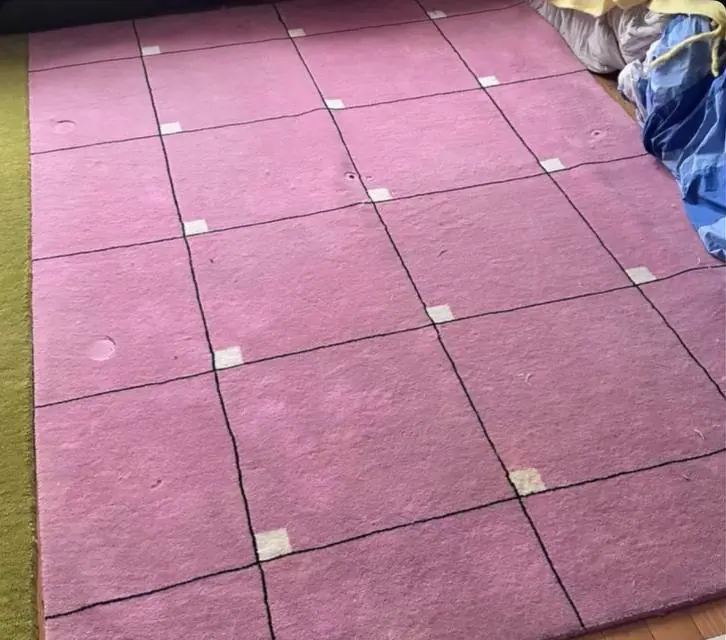 Before cleaning: pink geometric area rug