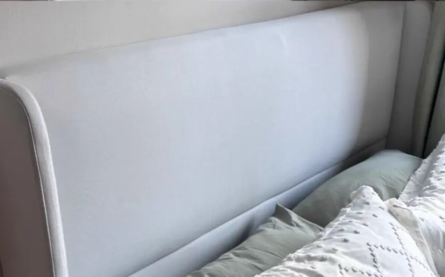 After cleaning: white upholstered headboard
